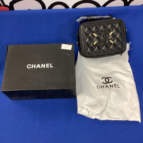 Vintage Chanel quilted handbag in black, classic designer purse.