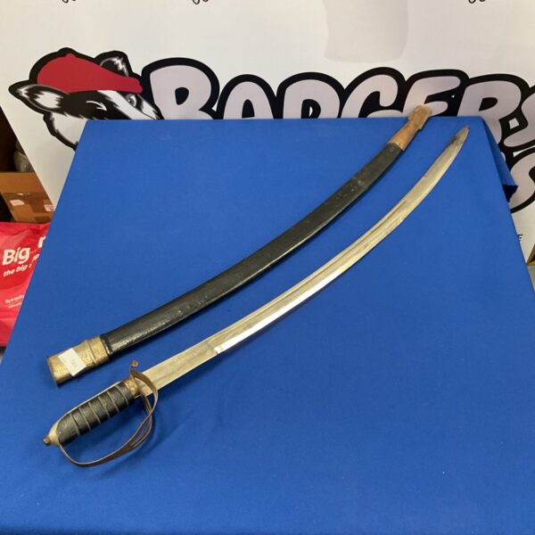 Antique Indian ceremonial sword with curved blade and ornate hilt.