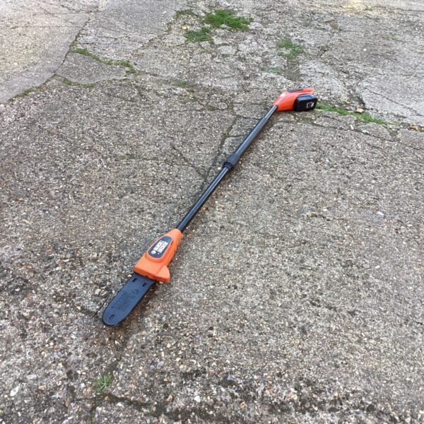 Black and Decker cordless pole saw for tree pruning and garden maintenance.