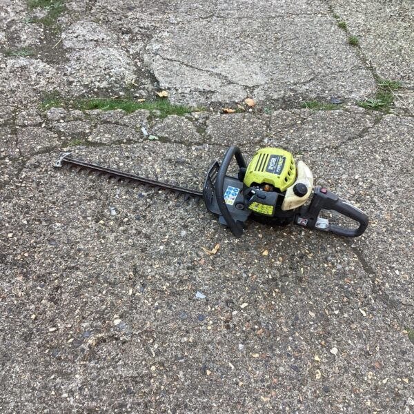 Ryobi petrol hedge trimmer for garden and landscaping use.
