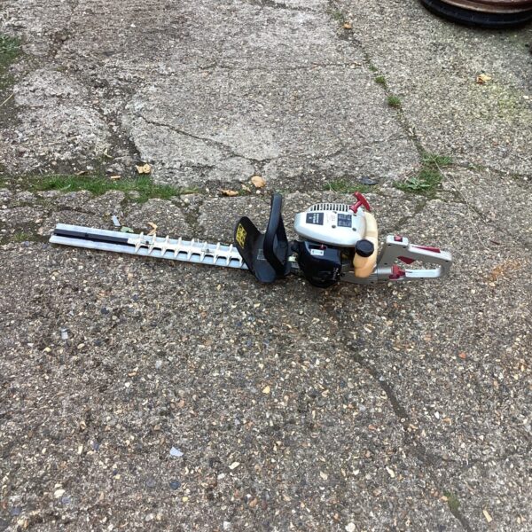 Used Spear and Jackson petrol hedge trimmer for garden maintenance.