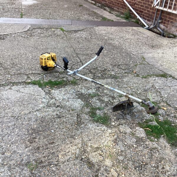 Used Pro Mac petrol strimmer for garden maintenance and trimming.