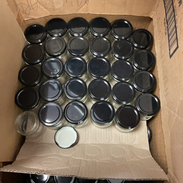 Lot of reusable glass preserve jars for canning and storage.