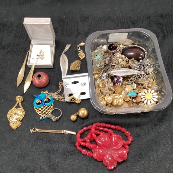 Costume jewellery lot with rings, earrings, and bracelets on display.