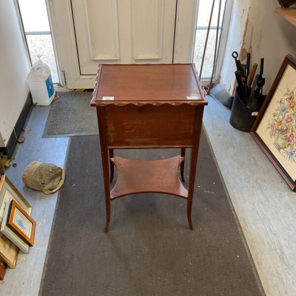Antique mahogany sewing table with lift-top and felt interior.