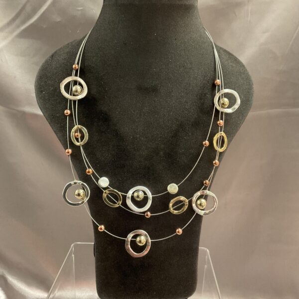 Close-up of vintage multi-ring necklace with graduated rings.