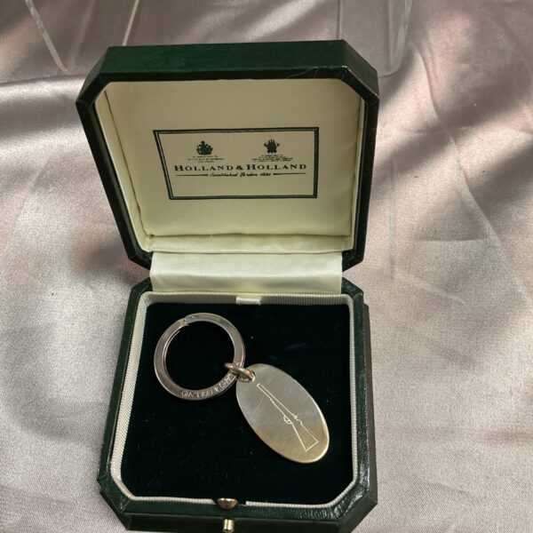 Holland & Holland silver key ring presented in a green box.
