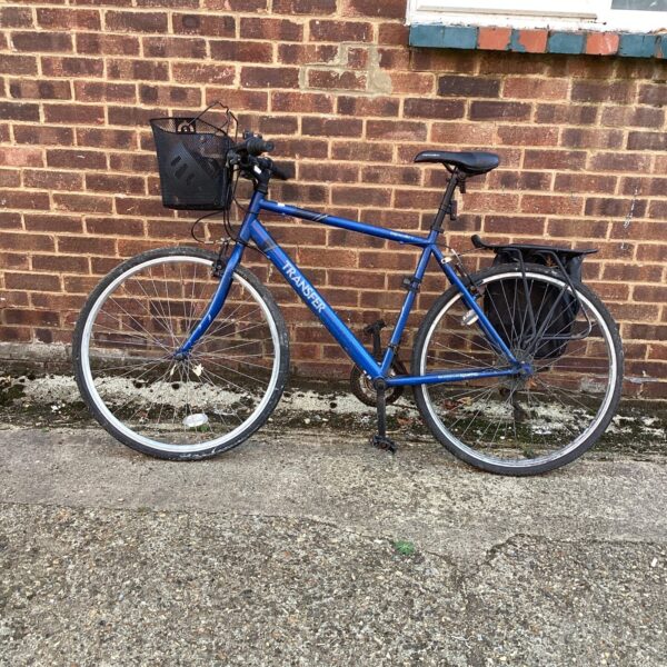 Blue Apollo Transfer bike with rear rack and mudguards.