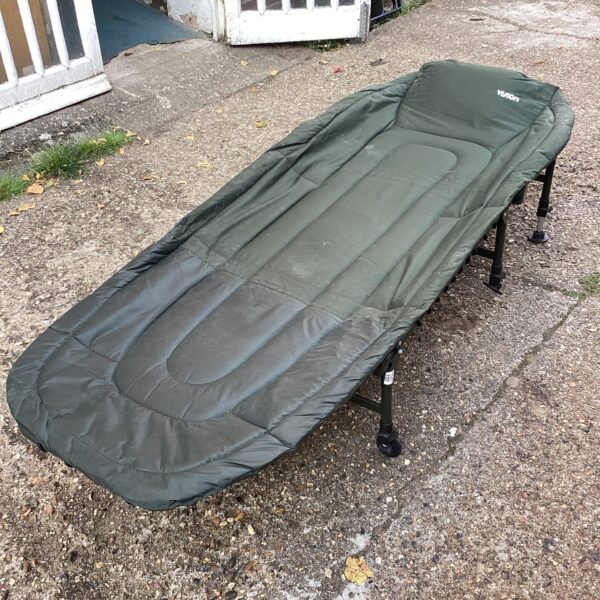 Front view of a used carp fishing bedchair.