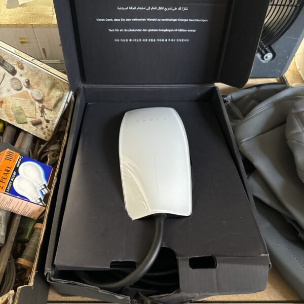 Tesla Wall Connector charger in its original packaging.