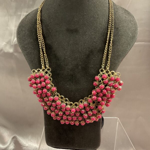 Vintage pink jade bead necklace with gold-toned chains.