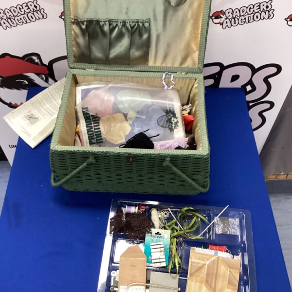 Open vintage sewing box with sewing supplies inside.
