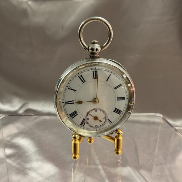 Antique silver pocket watch with Roman numerals.
