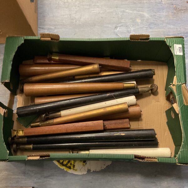 Tray of vintage wooden table legs for furniture restoration.