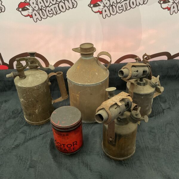 Vintage blow torches and oil cans in a workshop lot.