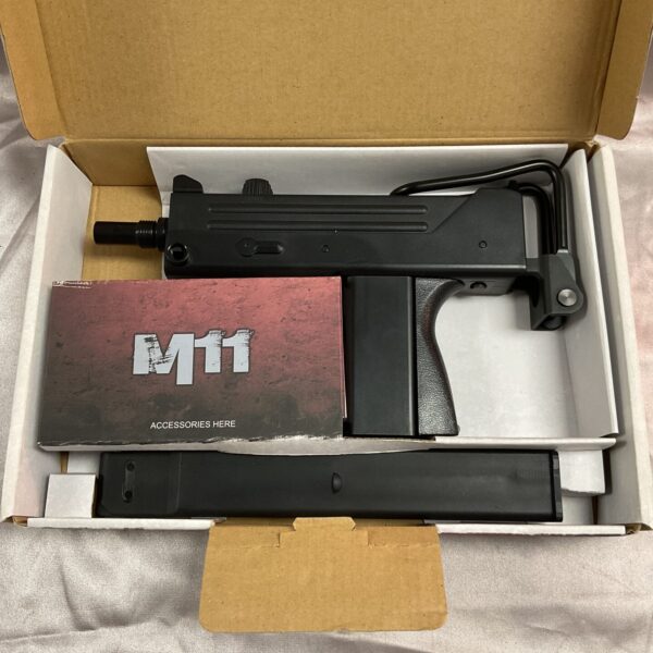 M11 air gun inside open cardboard box.
