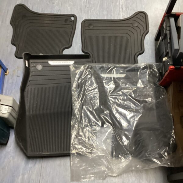 Set of dark-coloured Range Rover floor mats for vehicle protection.