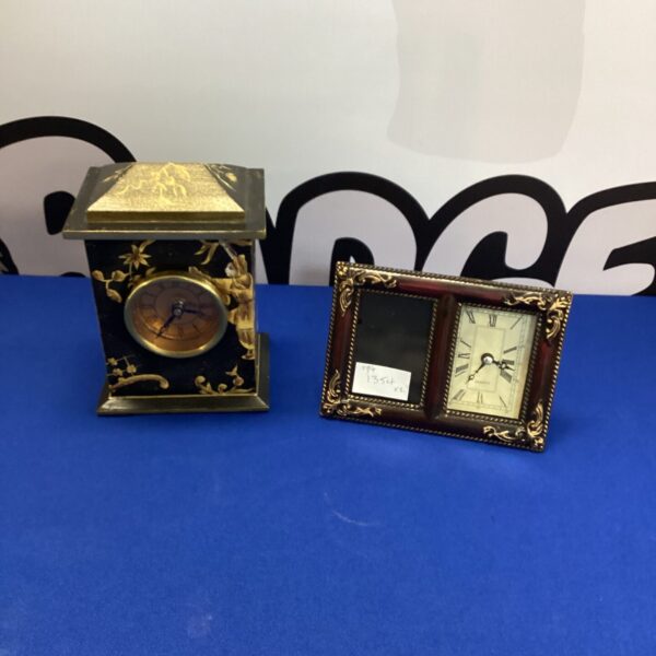 Gold-toned vintage quartz mantel clock on a dark surface.