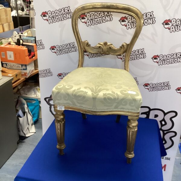 Vintage Regency style chair with gilded frame and floral upholstery.