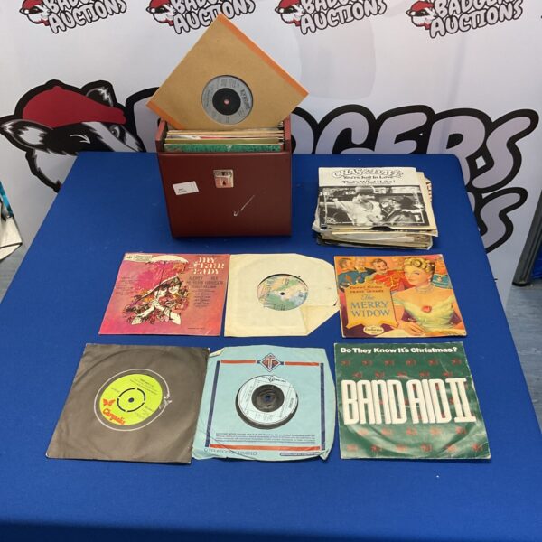 Vintage vinyl record collection in a cardboard box.