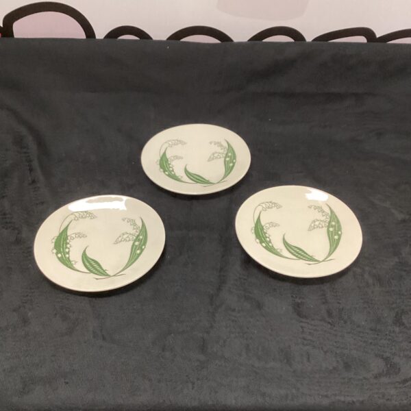 Vintage Clarice Cliff plates with floral design.