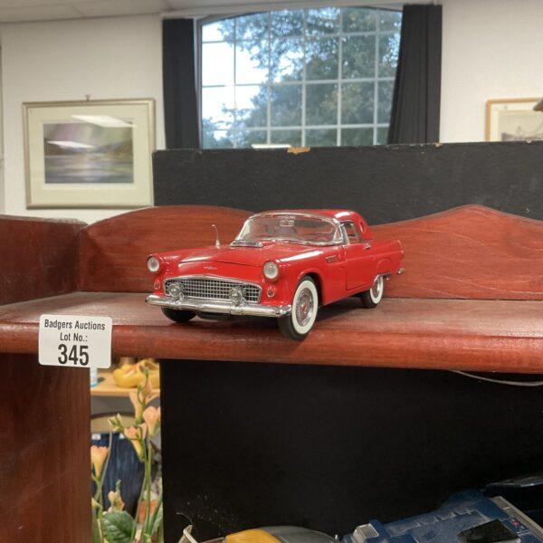 Red 1956 Ford Thunderbird model car, classic collectible.