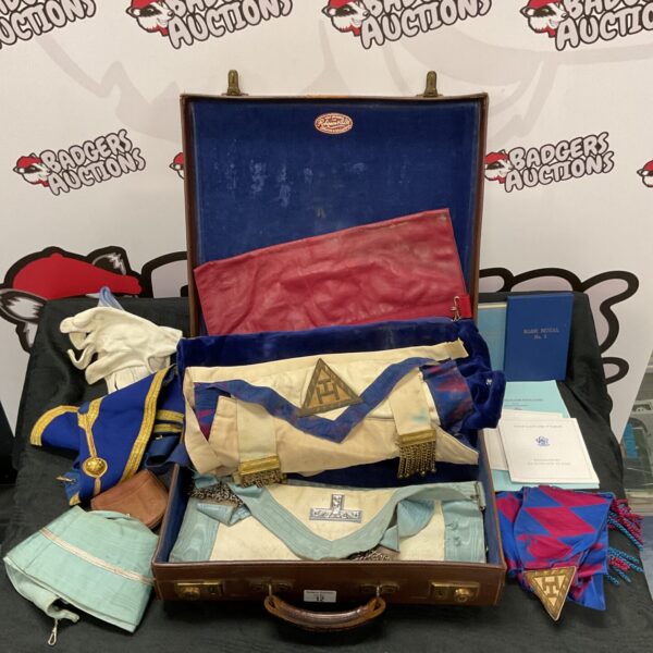 Vintage leather case containing a collection of Masonic aprons and sashes.