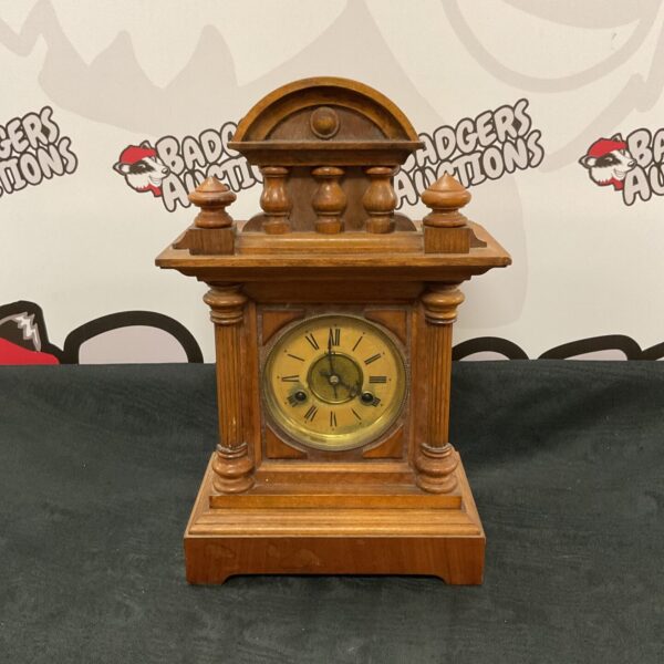 Vintage carved wood mantle clock with pendulum and key.