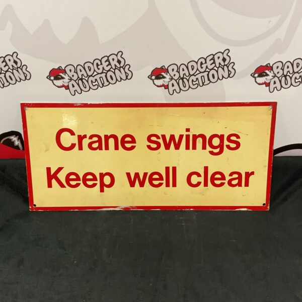Vintage crane swing sign with clear warning message.