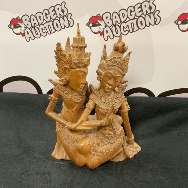 Detailed Balinese wood carving of Rama and Sita sculpture.