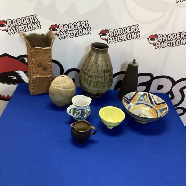 Assorted glazed pottery pieces including vases and a cup.