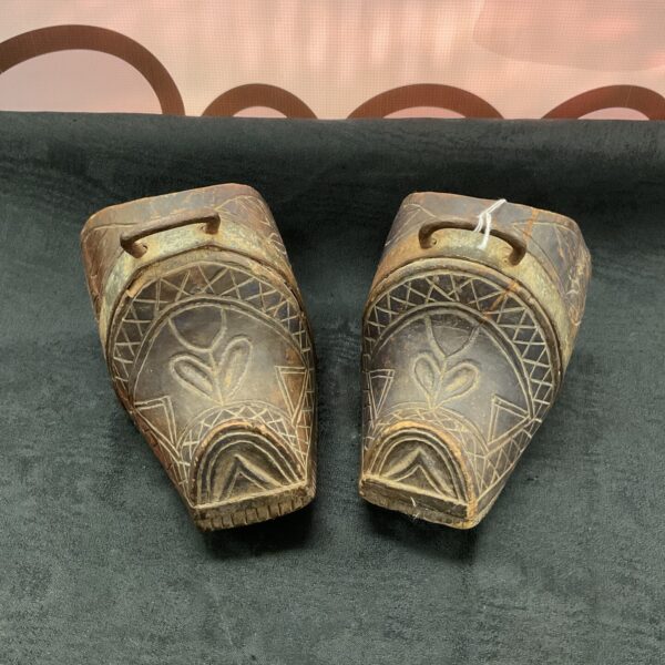 Antique gaucho stirrup sconces with carved wood detailing.
