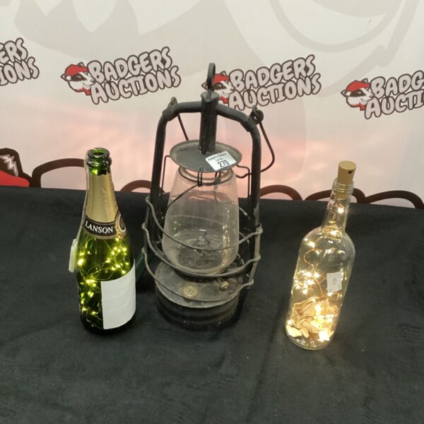 Rustic bottle lights and lantern for ambient home decor.