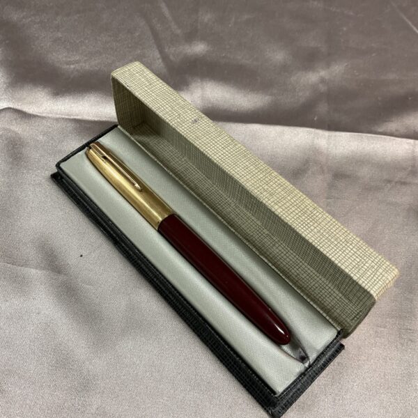 Vintage Parker fountain pen in burgundy with gold trim.