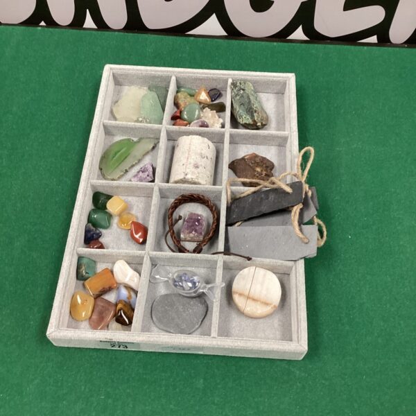 Assorted polished stones in a display tray, a colourful rock collection.