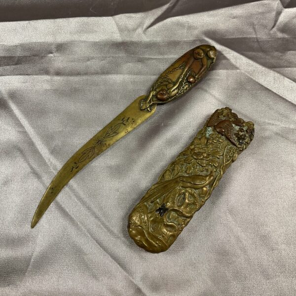 Ornate Indian brass letter opener with dragon head handle.
