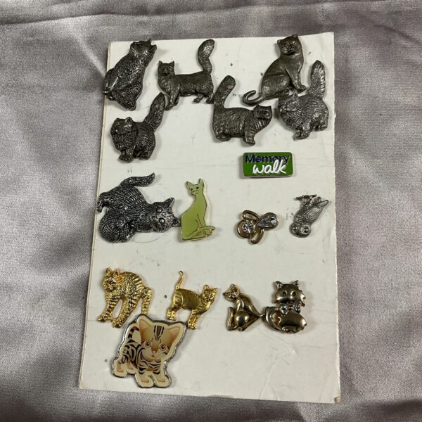 Vintage lot of cat brooches, enamel pins, and animal jewellery.