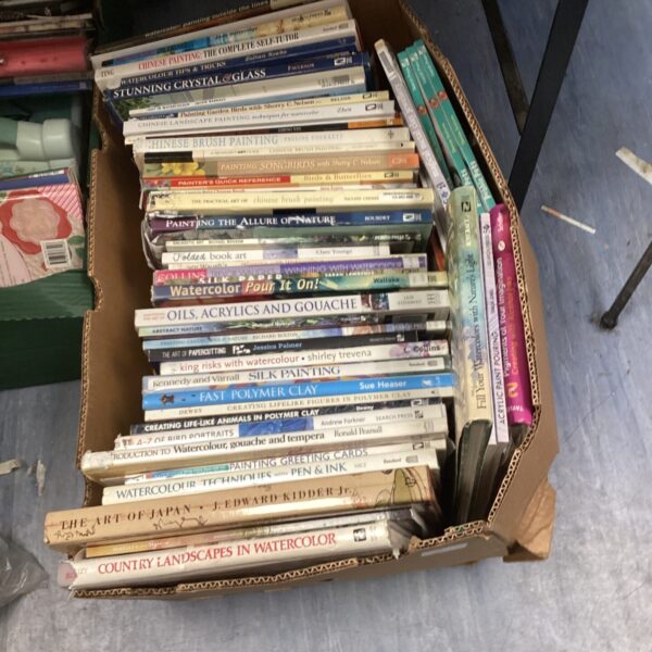 Stack of art instruction books on painting techniques.