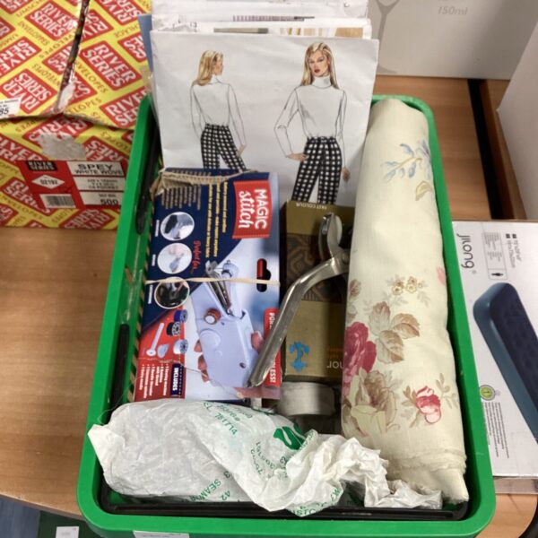 Dressmaking equipment lot with fabric and patterns.