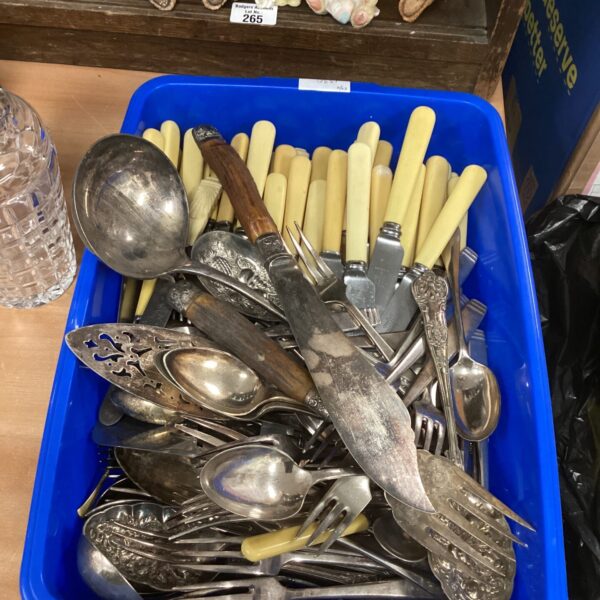 Mixed lot of vintage silver plate cutlery in a blue container.