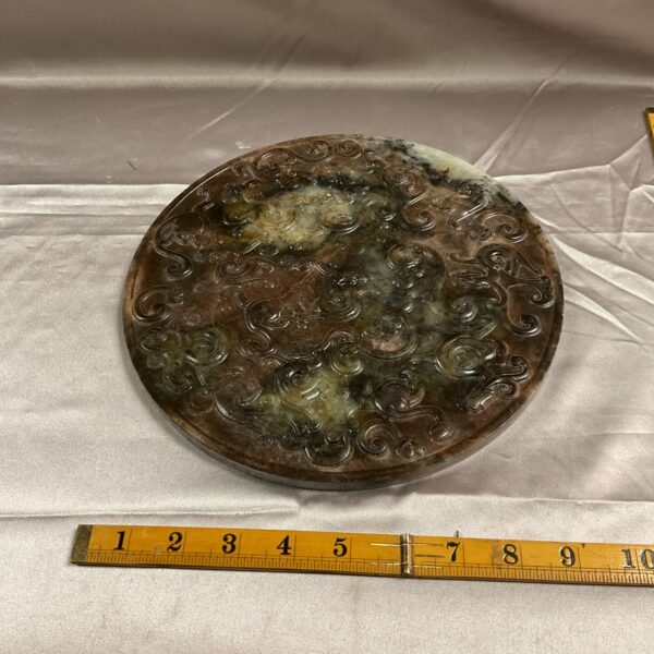 Intricate alabaster carved plate with floral design.