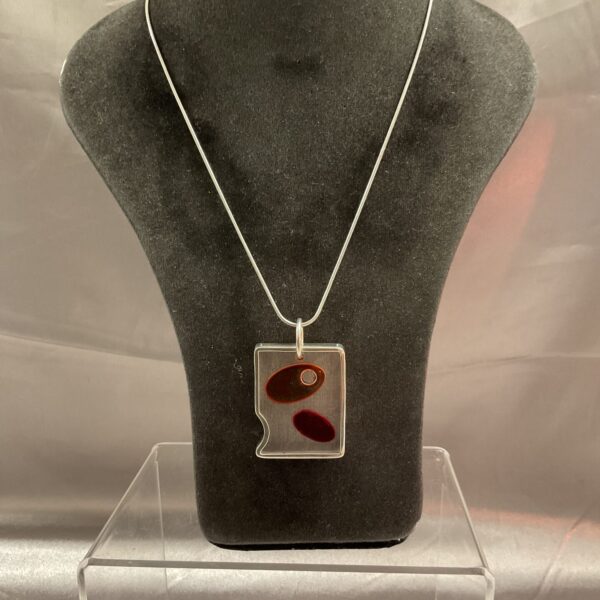 Vintage Italian silver modernist pendant necklace on display.