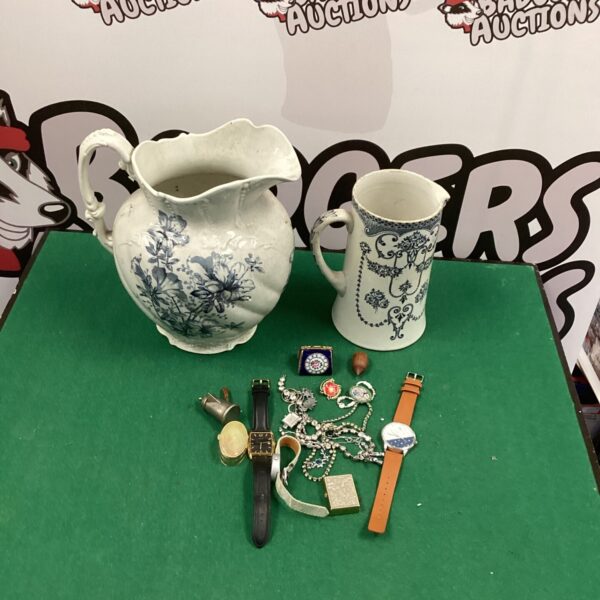 Antique porcelain jugs in a lot, featuring transferware designs.
