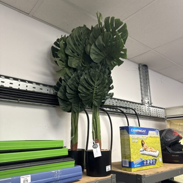 Two artificial plants in pots, ideal for home decor.