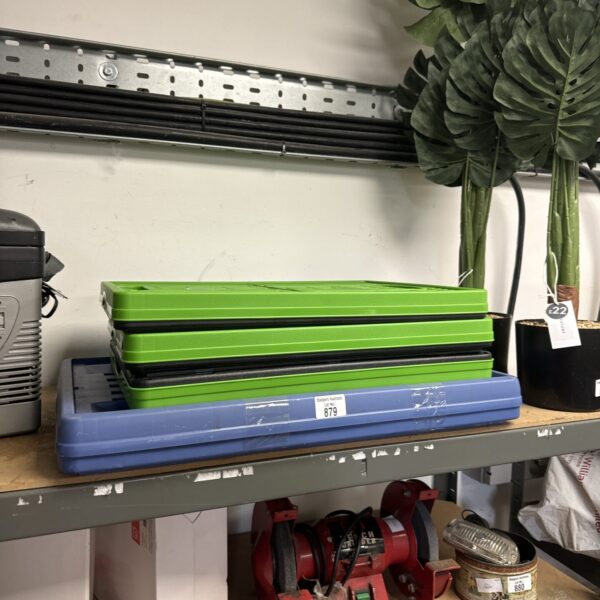 Blue and green folding storage crates stacked for organisation.