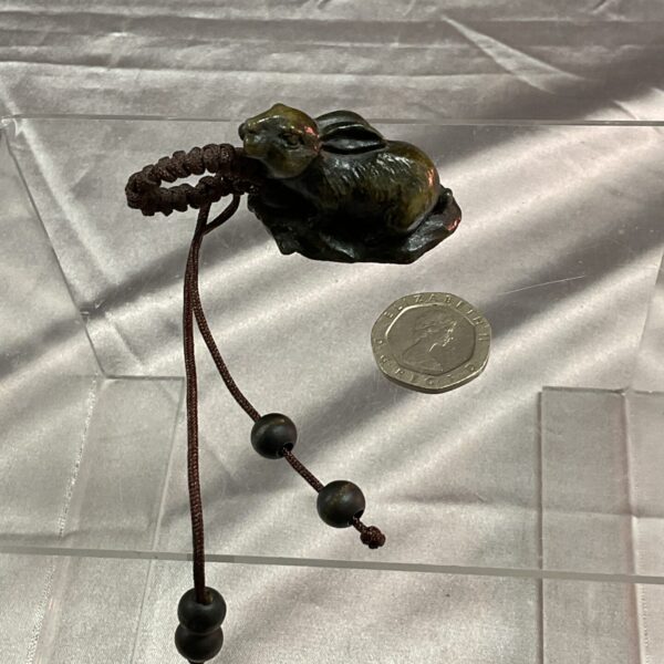Detailed resin rabbit netsuke sculpture with cord.