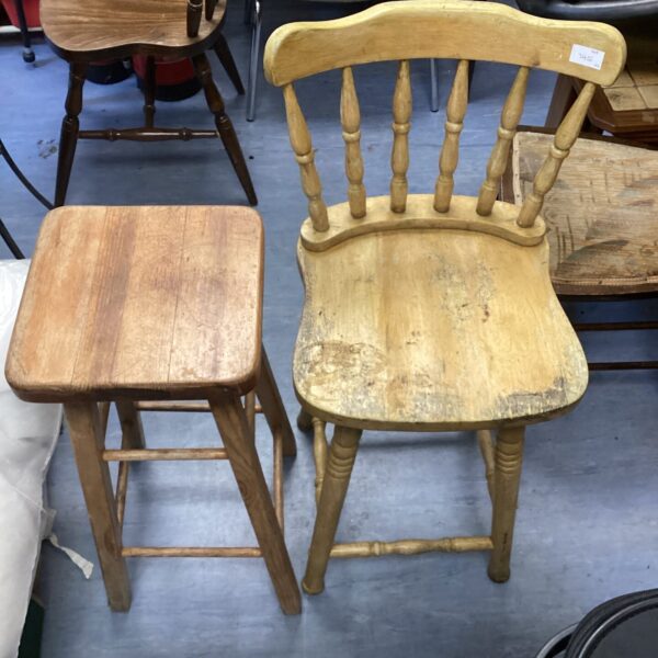 Vintage wooden stool with curved back, rustic farmhouse style.