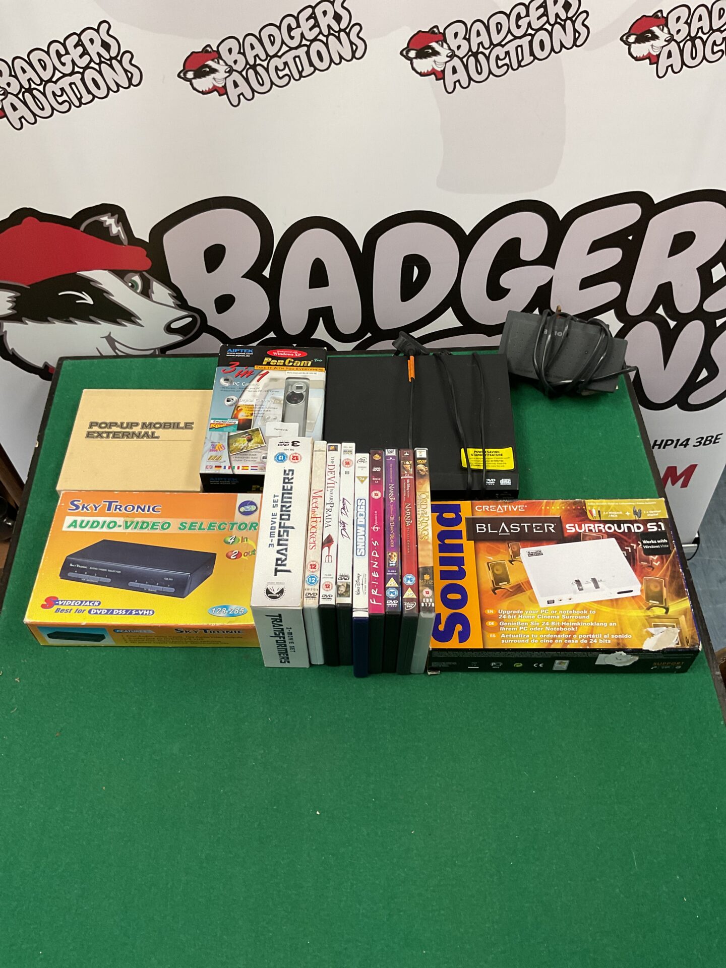 099 Box of mixed electrical goods including soundblaster soundcard and bush dvd player with large selection of dvds