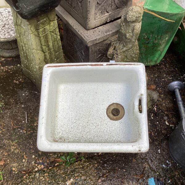 Vintage white enamel butlers sink with drain hole.