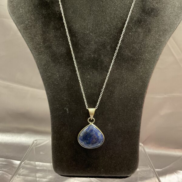 Stunning lapis lazuli necklace with a silver chain and blue gemstone pendant.